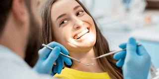 Brunette lady getting dental treatment