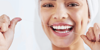 Lady flossing her teeth
