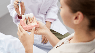 Dentist Showcasing Dental Implant