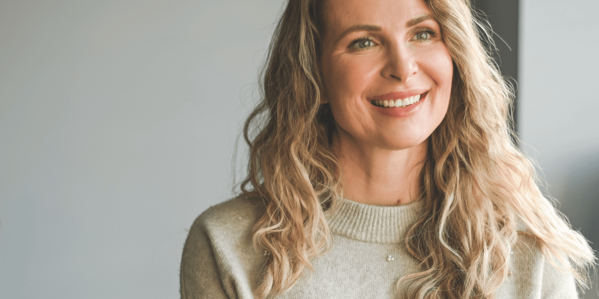 Smiling woman with natural makeup looking relaxed and confident