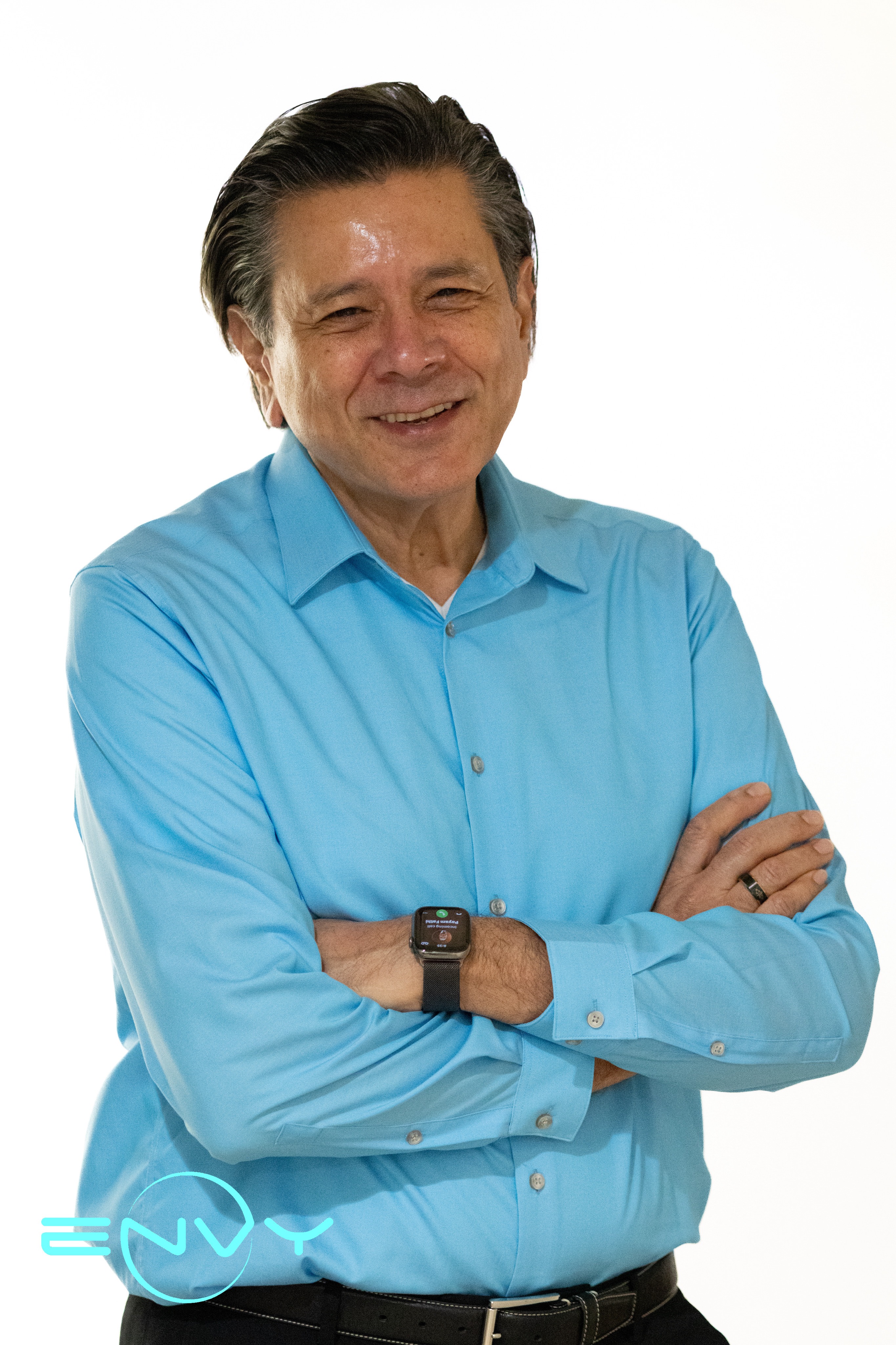 Mr. Jahan from ENVY Dental wearing a light blue shirt, smiling confidently.