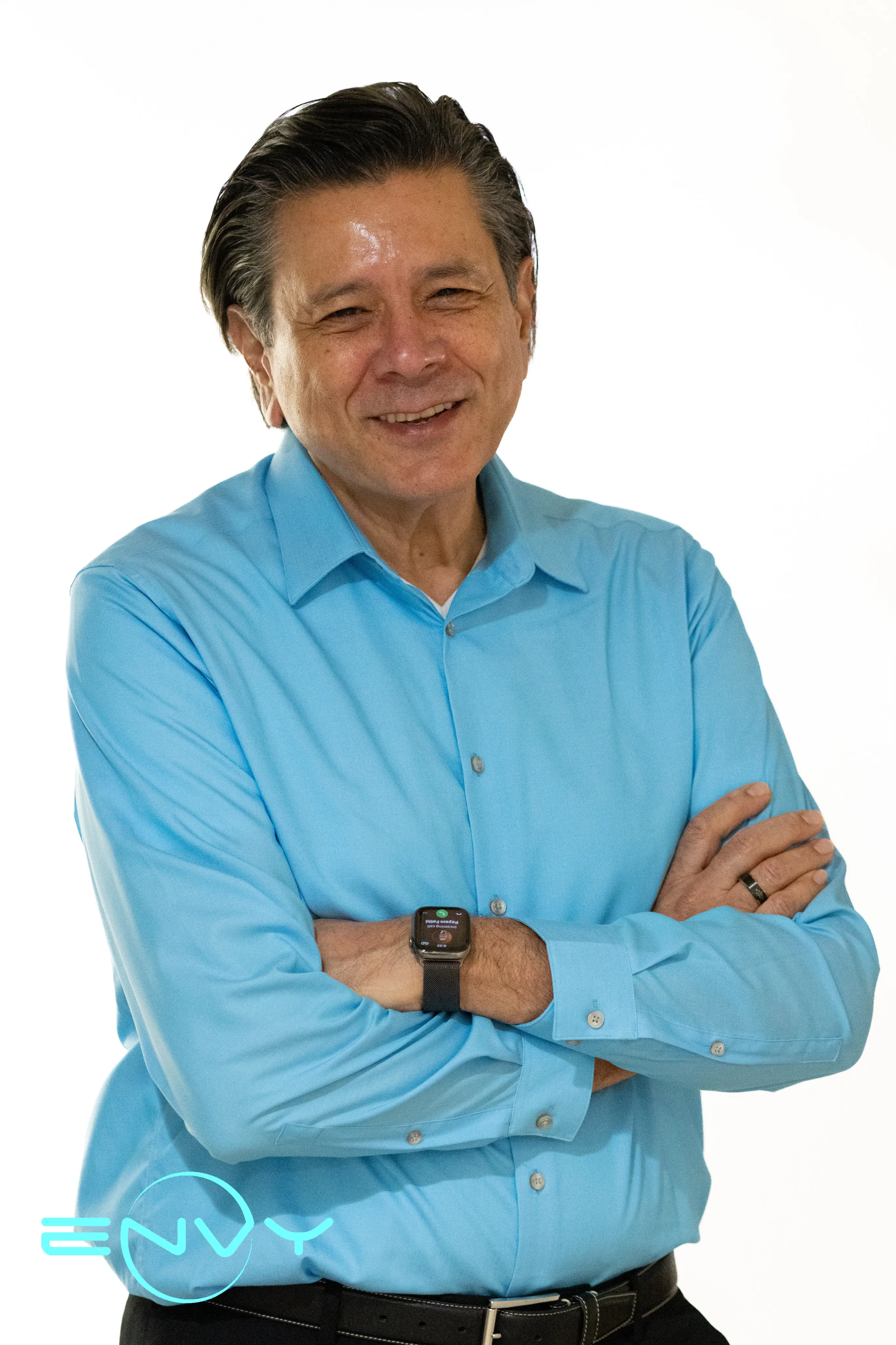 Mr. Jahan from ENVY Dental wearing a light blue shirt, smiling confidently.